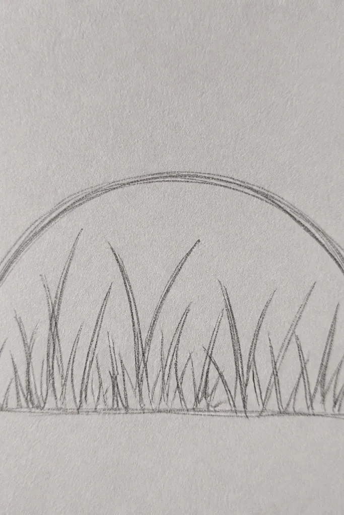 A simple arch shape at the top with grass drawn underneath. The grass grows upward from the bottom, with darker clumps near the arch base and lighter blades in the open space.